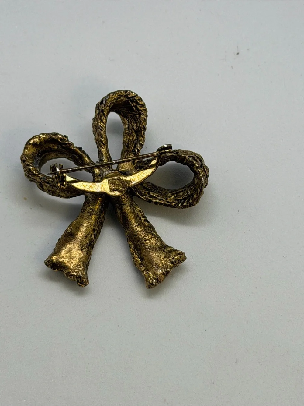 Gold-Tone Bow Brooch with Pink Center Stone